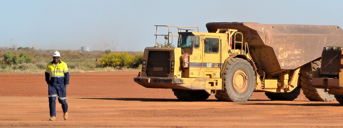 mine employee and trucks